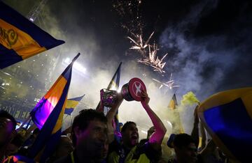 Boca Juniors' players celebrate with the trophy after they clinched the Argentine tournament