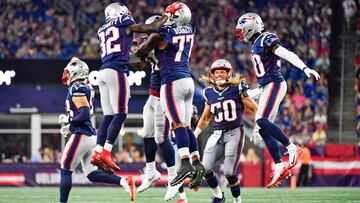 FOXBOROUGH, MA - AUGUST 22: Devin McCourty #32 celebrates with teammate Michael Bennett #77 of the New England Patriots after completing a sack in the second quarter of a preseason game against the Carolina Panthers at Gillette Stadium on August 22, 2019 in Foxborough, Massachusetts. (Photo by Kathryn Riley/Getty Images)