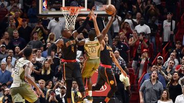 Nov 15, 2016; Miami, FL, USA; Miami Heat guard Dion Waiters (center) is pressured by Atlanta Hawks forward Paul Millsap (left) and forward Thabo Sefolosha (right) at the basket during the second half at American Airlines Arena. The Hawks won 93-90. Mandatory Credit: Steve Mitchell-USA TODAY Sports