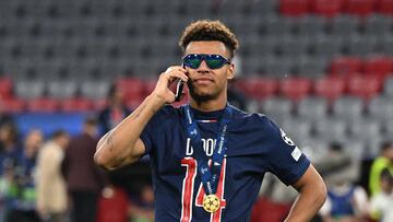 Soccer Football - Champions League - Final - Paris St Germain v Inter Milan - Allianz Arena, Munich, Germany - May 31, 2025 Paris St Germain's Desire Doue takes a call after winning the Champions League REUTERS/Angelika Warmuth