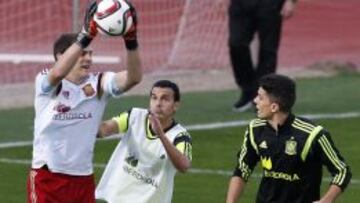 GRA409. LAS ROZAS (MADRID), 06/10/2015.- El portero de la selección española Iker Casillas (i) atrapa el balón ante sus compañeros Pedro Rodríguez (c) y Marc Bartra durante el entrenamiento celebrado esta tarde en las instalaciones de la Ciudad del Fútbol de Las Rozas, de preparación para el encuentro ante Luxemburgo, clasificatorio para la Eurocopa 2016 que se disputa el viernes en Logroño. EFE/Alberto Martin