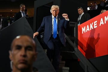 FILE PHOTO: Republican presidential nominee and former U.S. President Donald Trump raises is fist as he leaves at the conclusion of Day 2 of the Republican National Convention (RNC), at the Fiserv Forum in Milwaukee, Wisconsin, U.S., July 16, 2024. REUTERS/Callaghan O'hare/File Photo