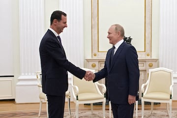 Russian President Vladimir Putin shakes hands with Syrian President Bashar al-Assad during a meeting at the Kremlin in Moscow, Russia, September 13, 2021.