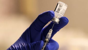 (FILES) In this file photo a pharmacist fills a syringe to prepare a dose of the Pfizer-BioNTech Covid-19 vaccine for front-line health care workers at a vaccination site at Torrance Memorial Medical Center on December 19, 2020 in Torrance, California. - 