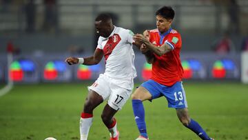 LIMA, PERU - OCTOBER 07: Luis Adv&iacute;ncula of Peru fights for the ball with Erick Pulgar of Chile during a match between Peru and Chile as part of South American Qualifiers for Qatar 2022 at Estadio Nacional on October 07, 2021 in Lima, Peru. (Photo b