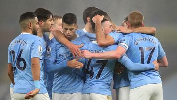 MANCHESTER, ENGLAND - JANUARY 13: Phil Foden of Manchester City celebrates with teammates Joao Cancelo, Rodrigo and Kevin De Bruyne after scoring their team's first goal during the Premier League match between Manchester City and Brighton & Hove