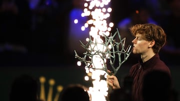 Italy's Jannik Sinner celebrates with the trophy after winning the men's singles final match of the Paris ATP Masters 1000 tennis tournament against Canada's Felix Auger-Aliassime at the Paris La D�fense Arena in Nanterre, on the outskirts of Paris, on November 2, 2025. (Photo by Dimitar DILKOFF / AFP)