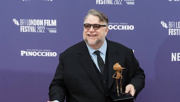 Director Guillermo del Toro holds a figurine of Pinocchio as he attends the world premiere of 'Pinocchio' at the Royal Festival Hall during the 66th BFI London Film Festival in London.