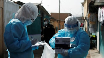 Healthcare workers wearing personal protective equipment (PPE) check the result of tests for the coronavirus disease (COVID-19) in Cantagallo, an indigenous Shipibo-Conibo community, during the vaccination campaign against the coronavirus, in Lima, Peru February 19, 2021. REUTERS/Angela Ponce