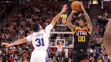 Nov 16, 2021; Salt Lake City, Utah, USA; Utah Jazz guard Jordan Clarkson (00) shoots the ball over Philadelphia 76ers guard Seth Curry (31) during the third quarter at Vivint Arena. Utah Jazz won 120-85. Mandatory Credit: Chris Nicoll-USA TODAY Sports