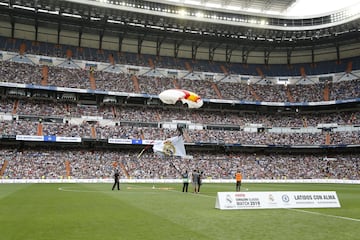 Parachuters land on the field before the game.