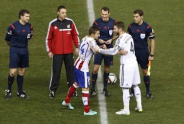 El árbitro Clos Gómez con los capitanes Gabi y Sergio Ramos.
