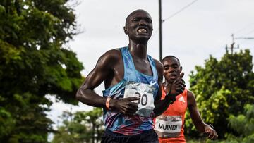 Kenyan athletes Joseph Kiprono (L) and Daniel Muindi run the 21km race at the Medellin Flowers Marathon, in the Colombian city of Medellin on September 16, 2018. - Kiprono was hit by a car as he was leading the race 1.5km prior to the finish line and was 