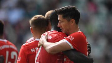 14 May 2022, Lower Saxony, Wolfsburg: Soccer: Bundesliga, VfL Wolfsburg - Bayern Munich, Matchday 34, Volkswagen Arena. Munich's Robert Lewandowski celebrates with Munich's Dayot Upamecano after his goal to make it 0:2. Photo: Swen Pförtner/dpa - IMPORTANT NOTE: In accordance with the requirements of the DFL Deutsche Fußball Liga and the DFB Deutscher Fußball-Bund, it is prohibited to use or have used photographs taken in the stadium and/or of the match in the form of sequence pictures and/or video-like photo series. (Photo by Swen Pförtner/picture alliance via Getty Images)