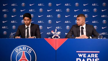 (FILES) Paris Saint-Germain's CEO Nasser Al-Khelaifi (L) and French forward Kylian Mbappe (R) give a press conference at the Parc des Princes stadium in Paris on May 23, 2022, two days after the club won the Ligue 1 title for a record-equalling tenth time and its superstar striker Mbappe chose to sign a new contract at PSG rather than join Real Madrid. French champions Paris Saint-Germain have left Kylian Mbappe out of their squad for a pre-season tour of Japan, casting further doubt on the star striker's future. Mbappe declared in May 2023 that he would not extend his PSG contract, which expires next year, but indicated he wanted to remain at the club for a final season. (Photo by FRANCK FIFE / AFP)