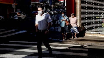 Imagen de varias personas cruzando un paso de peatones con mascarillas en la ciudad de Ribeirao Preto (Brasil).