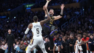 Mar 3, 2026; Los Angeles, California, USA; Los Angeles Lakers guard Luka Doncic (77) shoots the ball against New Orleans Pelicans guard Dejounte Murray (5)in the second half at Crypto.com Arena. Mandatory Credit: Kirby Lee-Imagn Images