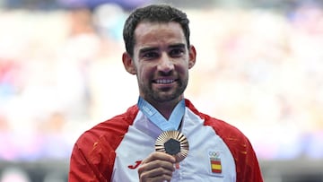Bronze Medalist Spain's Alvaro Martin celebrates on the podium after competing in the men's 20km race walk of the athletics event, at the Paris 2024 Olympic Games at Stade de France in Saint-Denis, north of Paris, on August 2, 2024. (Photo by Andrej ISAKOVIC / AFP)
