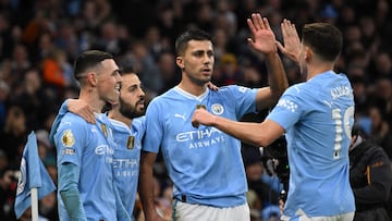 Manchester City's Spanish midfielder #16 Rodri (C) celebrates with teammates after scoring the opening goal of the English Premier League football match between Manchester City and Sheffield United at the Etihad Stadium in Manchester, north west England, on December 30, 2023. (Photo by Oli SCARFF / AFP) / RESTRICTED TO EDITORIAL USE. No use with unauthorized audio, video, data, fixture lists, club/league logos or 'live' services. Online in-match use limited to 120 images. An additional 40 images may be used in extra time. No video emulation. Social media in-match use limited to 120 images. An additional 40 images may be used in extra time. No use in betting publications, games or single club/league/player publications. / 