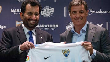 Malaga's new coach Jose Miguel Gonzalez Martin del Campo aka Michel (R) poses with Malaga CF's chairman Sheikh Abdallah Ben Nasser Al-Thani during his official presentation at the Rosaleda stadium in Malaga, on March 8, 2017.  / AFP PHOTO / JORGE GUERRERO