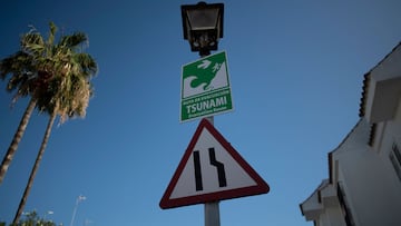 A picture taken in Chipiona, southern Spain, on November 6, 2023 shows a sign in the street showing the direction to go in case of a tsunami during an annual tsunami drill. (Photo by JORGE GUERRERO / AFP)