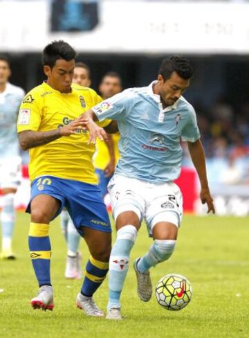 El defensa argentino del Celta de Vigo, Gustavo Cabral, pugna por un balón con el delantero del Las Palmas, Sergio Araujo, en el partido de la tercera jornada de Liga jugado en el estadio de Balaídos