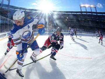 Jan 1, 2018; Queens, NY, USA; Buffalo Sabres center Jack Eichel (15) battles for the puck with New York Rangers defenseman Marc Staal (18) during the first period in the 2018 Winter Classic hockey game at Citi Field. Mandatory Credit: Brad Penner-USA TODA