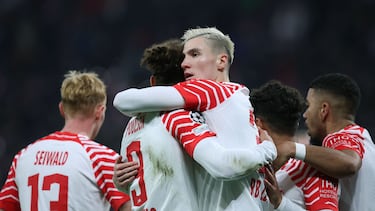 Leipzig's Slovenian forward #30 Benjamin Sesko (C-R) celebrates with Leipzig's Danish forward #09 Yussuf Poulsen (C-L) and teammates after scoring the 1-0 opening goal during the UEFA Champions League group G football match between RB Leipzig and Young Boys in Leipzig, eastern Germany, on December 13, 2023. (Photo by Ronny HARTMANN / AFP)