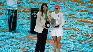 La tenista polaca Iga Swiatek acompañada por la extenista Garbiñe Muguruza tras recibir el trofeo como vencedora en la final individual femenina del Madrid Open.