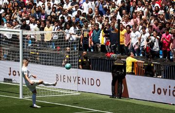 Luka Jovic kicks balls into the stands during today's presentation.