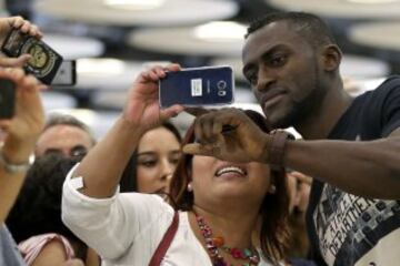 El colombiano Jackson Martínez, delantero del Atlético de Madrid, se fotografía con aficionados a su llegada esta tarde al aeropuerto Adolfo Suárez-Barajas de Madrid. Martínez ha sido traspasado desde el Porto a cambio de la cantidad de su cláusula de rescisión, 35 millones de euros.