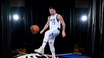 Dallas Mavericks guard Luka Doncic (77) dribbles the basketball in soccer style as he poses for a photo during the 2024 Dallas Mavericks media day.