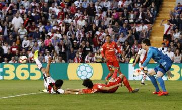 Guerra (left) and Vallejo (second left) tumble to the turf in the incident that led to Rayo Vallecano's first-half penalty.