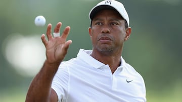 (FILES) In this file photo taken on May 17, 2022, Tiger Woods catches a ball during a practice round prior to the start of the 2022 PGA Championship at Southern Hills Country Club in Tulsa, Oklahoma. - Woods announced on June 7, 2022, that he will not play next week's US Open at Brookline to continue his recovery from severe leg injuries sustained in a car accident last year. The 15-time major champion withdrew from the PGA Championship last month after the third round. (Photo by Christian Petersen / GETTY IMAGES NORTH AMERICA / AFP)