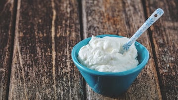 Skyr quark yoghurt in a blue bowl on a wooden table