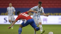 BRASILIA, BRAZIL - JUNE 21: Alberto Espinola of Paraguay competes for the ball with Nicolas Tagliafico of Argentina during a group A match between Argentina and Paraguay as part of Conmebol Copa America Brazil 2021 at Mane Garrincha Stadium on June 21, 2021 in Brasilia, Brazil. (Photo by Pedro Vilela/Getty Images)