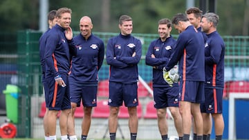 RB Leipzig's new coach Julian Nagelsmann (L), the training team Benjamin Glueck, Ruwen Faller, Robert Klauss, Moritz Volz, Daniel Behlau, Kai Kraft and goalkeeper coach Frederik Goessling stand on the pitch after the first training session ahead of the upcoming season German First division Bundesliga football, on July 8, 2019 in Leipzig. (Photo by Jan Woitas / dpa / AFP) / Germany OUT