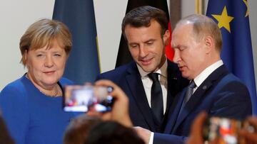 FILE PHOTO: German Chancellor Angela Merkel, French President Emmanuel Macron and Russia's President Vladimir Putin attend a joint news conference after a Normandy-format summit in Paris, France December 9, 2019. REUTERS/Charles Platiau/Pool/File Photo