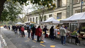 People queue keeping a security distance to buy groceries at a street market during the lockdown imposed by the government against the spread of the new coronavirus, COVID-19, in Buenos Aires, Argentina, on May 15, 2020. (Photo by JUAN MABROMATA / AFP)