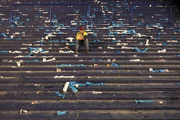 A supporter of Argentina sits on the stands at the end of the goalless 2018 World Cup football qualifier match against Peru in Buenos Aires on October 5, 2017. / 