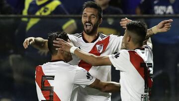River Plate's forward Ignacio Scocco (C) celebrates with teammates after scoring the team's second goal against Boca Juniors during their Argentina First Division Superliga football match at La Bombonera stadium, in Buenos Aires, on September 23