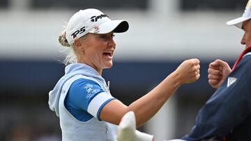 England's Charley Hull reacts with her caddie leaving the 18th green on day 3 of the 2023 Women's British Open Golf Championship at Walton Heath Golf Club in Walton-on-the-Hill, south-west of London on August 12, 2023. (Photo by Glyn KIRK / AFP) / RESTRICTED TO EDITORIAL USE