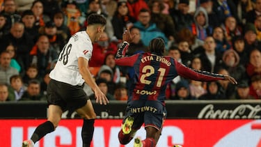 VALENCIA, 21/11/2025.- El delantero camerunés del Levante, Karl Etta Eyong (d), cae el centrocampista del Valencia, Pepelu, durante el encuentro correspondiente a la jornada 13 de Laliga EA Sports que disputan hoy viernes Valencia y Levante en el estadio valencianista de Mestalla. EFE / Manuel Bruque.