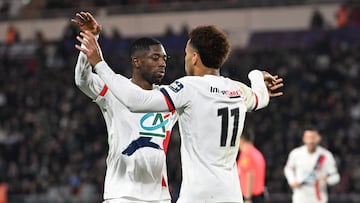 Paris Saint-Germain's French midfielder #14 Desire Doue (R) celebrates Paris Saint-Germain's French forward #10 Ousmane Dembele after scoring a goal during the French Cup round of 64 football match between Fontenay-le-Comte and Paris Saint-Germain (PSG) at La Beaujoire stadium, in Nantes, western France, on December 20, 2025. (Photo by Sebastien Salom-Gomis / AFP)