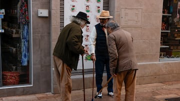 Pensioners compare their walking sticks in a street in Ronda, Spain, January 30, 2024. REUTERS/Jon Nazca