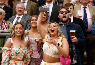 Racegoers attend the second day of the Grand National Festival horse race meeting at Aintree Racecourse in Liverpool, north-west England, on April 12, 2024. (Photo by Oli SCARFF / AFP)