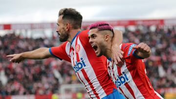 Girona's Uruguayan forward #07 Cristhian Stuani and Girona's Brazilian defender #20 Yan Couto celebrate Valencia's Spanish defender #03 Cristhian Mosquera's owngoal during the Spanish league football match between Girona FC and Valencia CF at the Montilivi stadium in Girona on December 1, 2023. (Photo by LLUIS GENE / AFP)
