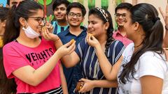 Students offer sweets to eachother as they celebrate their results of Class 10th examinations announced by the Central Board of Secondary Education (CBSE) at DAV public school in Amritsar on July 15, 2020. (Photo by NARINDER NANU / AFP)