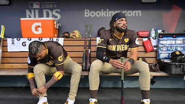 Oct 11, 2024; Los Angeles, California, USA; San Diego Padres first baseman Luis Arraez (4) and outfielder Fernando Tatis Jr. (23) look on in the dugout before game five against the Los Angeles Dodgers in the NLDS for the 2024 MLB Playoffs at Dodger Stadium. Mandatory Credit: Jayne Kamin-Oncea-Imagn Images