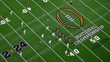 HOUSTON, TEXAS - JANUARY 08: J.J. McCarthy #9 of the Michigan Wolverines calls a play in the first quarter against the Washington Huskies during the 2024 CFP National Championship game at NRG Stadium on January 08, 2024 in Houston, Texas.   Logan Riely/Getty Images/AFP (Photo by Logan Riely / GETTY IMAGES NORTH AMERICA / Getty Images via AFP)